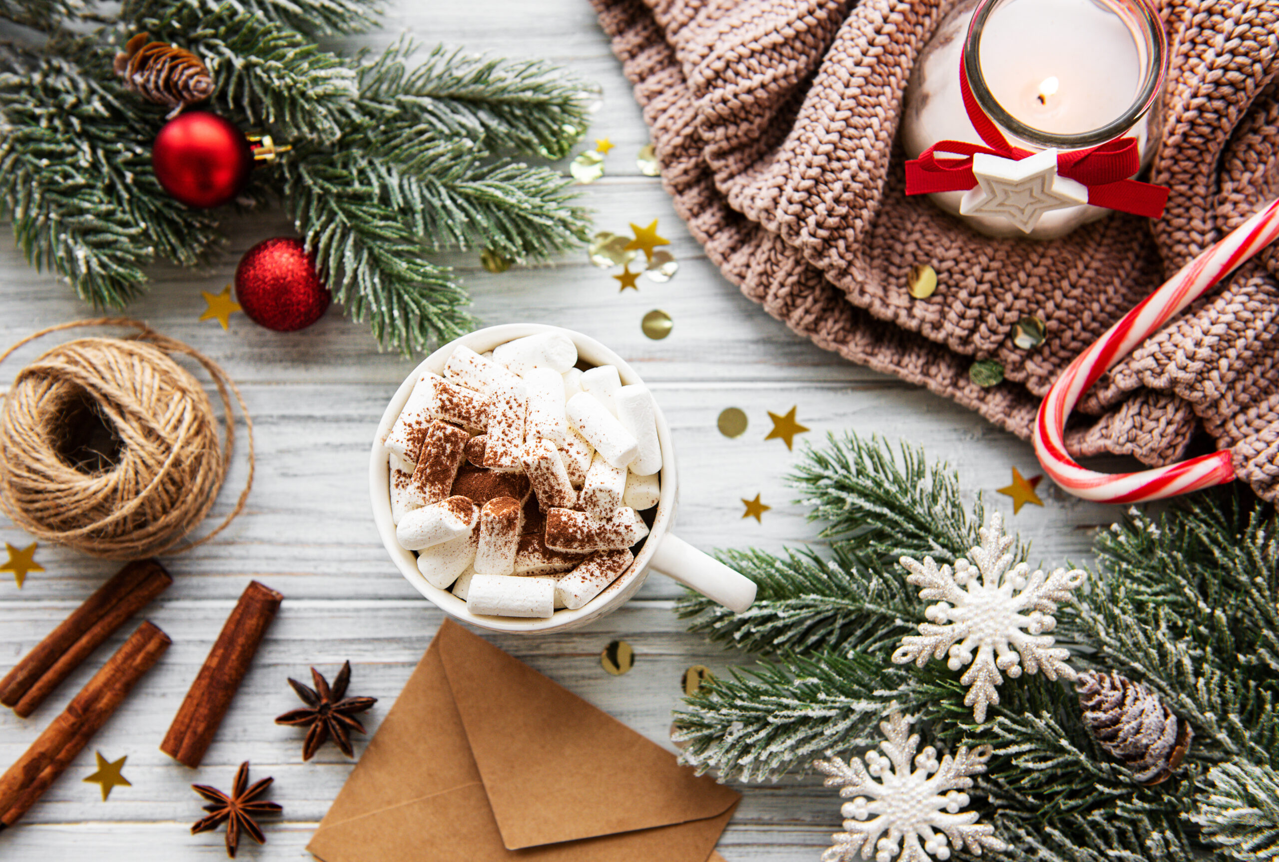 Christmas Tree Pine Branches with decorations  and Hot Chocolate on a wooden table. Holiday background with copyspace. Top view